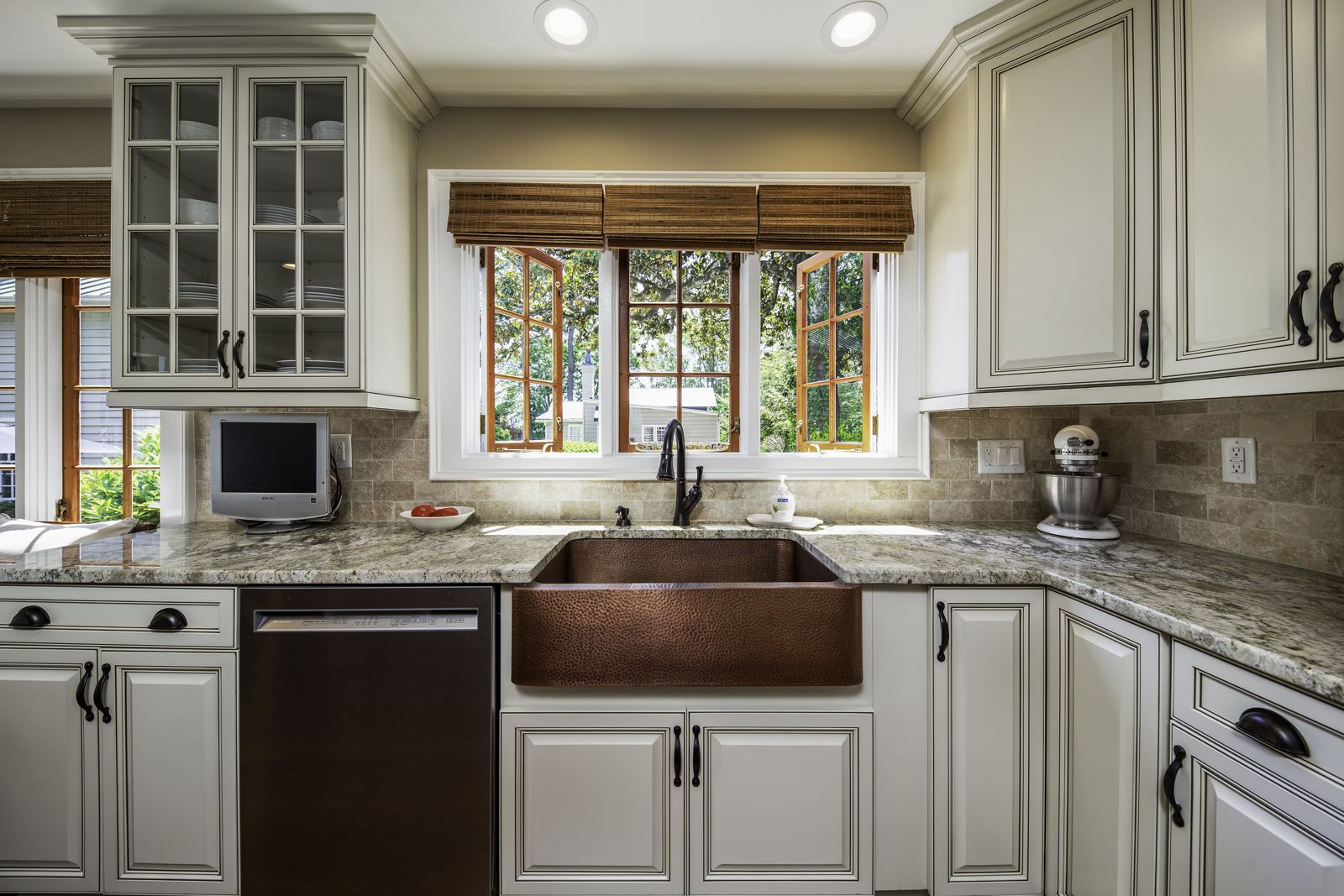 Copper farmhouse sink with glass-front upper cabinets