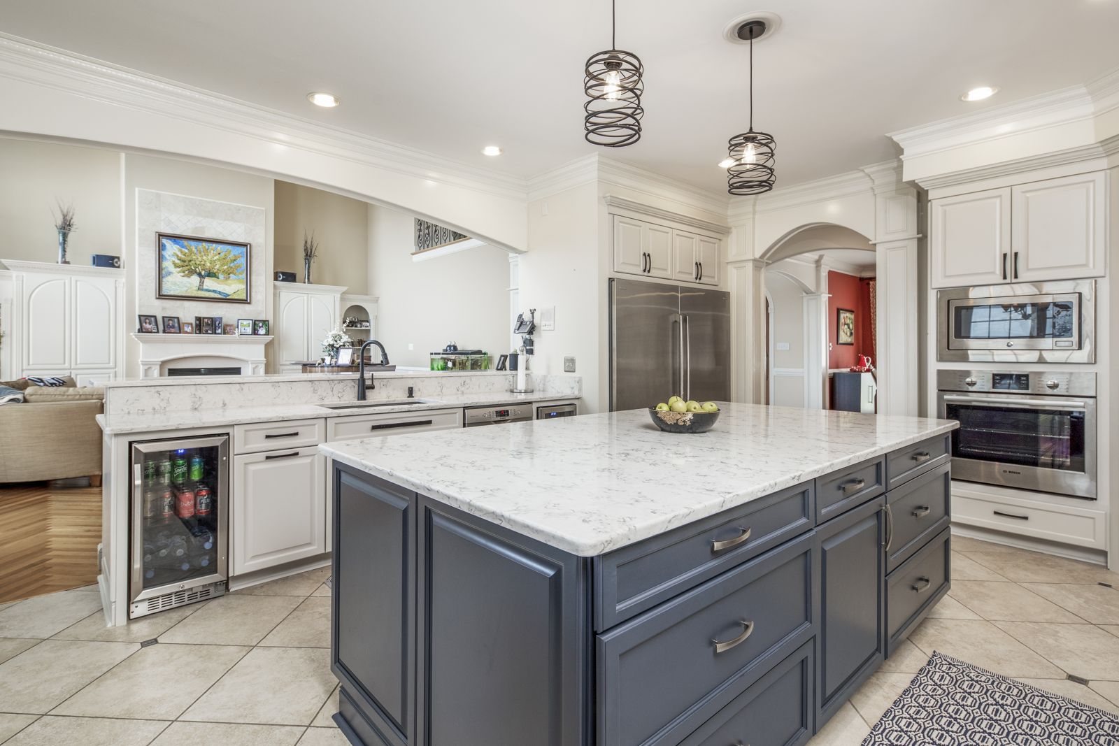 White kitchen with navy island and semi-custom cabinetry