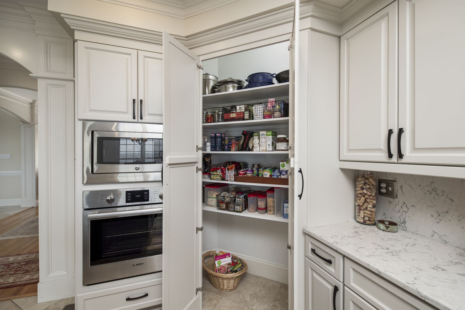Wall ovens and pantry built-ins with painted cabinets